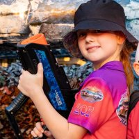 girl smiles holding a fun tagger