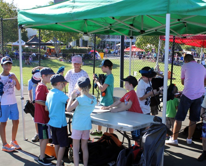 kids lining up for the laser tag games at a school fete 